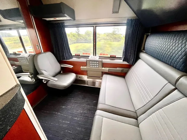 Amtrak private Bedroom with a sofa, armchair, and window
